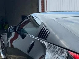 a sports car about to drive inside a lock up garage