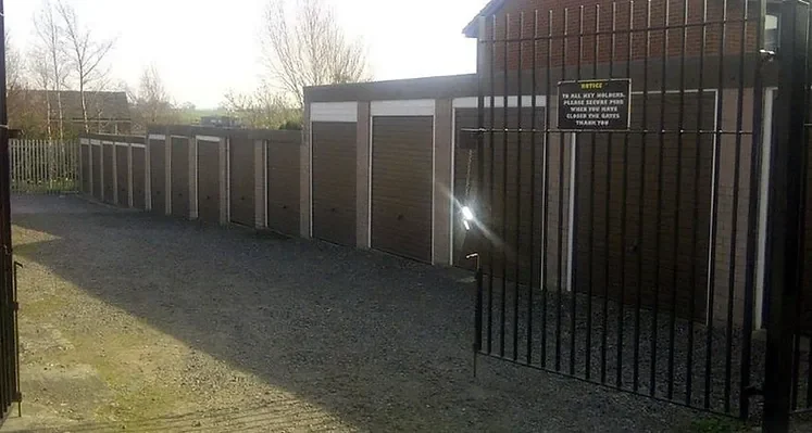 a parade of lock up garages in a gated compound