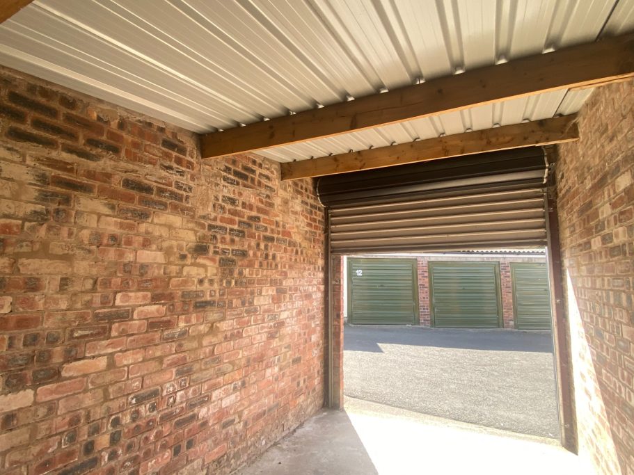 the interior of an empty lock up garage used for storage