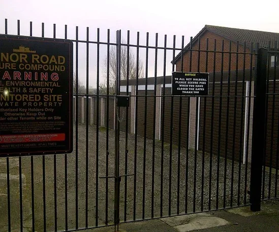 locked gates in front of a colony of lock up garages