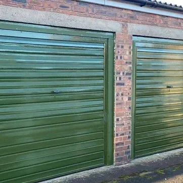 Two green lock up garages