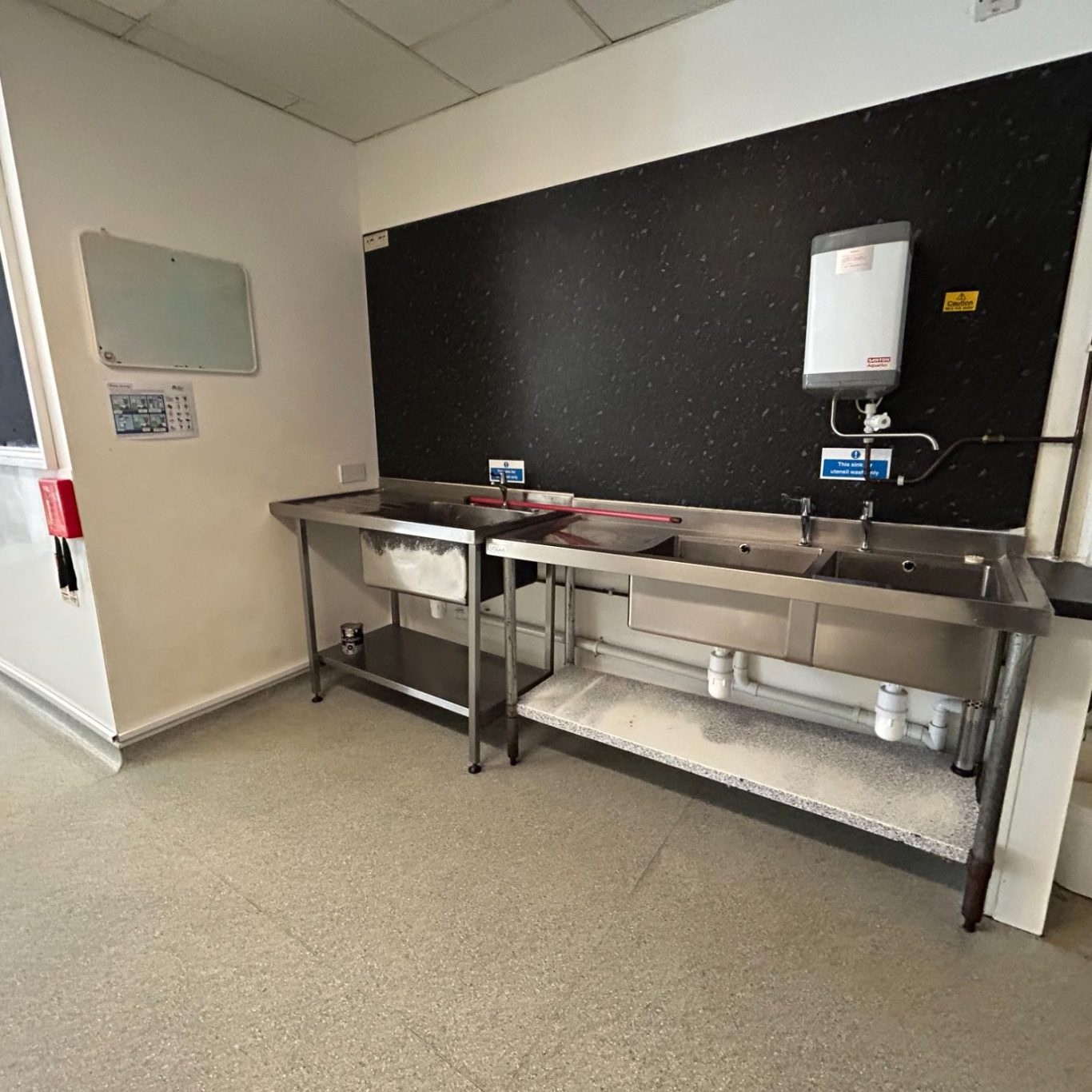 the kitchen inside of a commercial property for sale