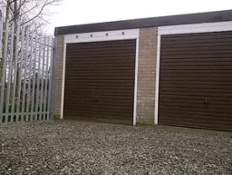 two lock up garages with brown metal doors