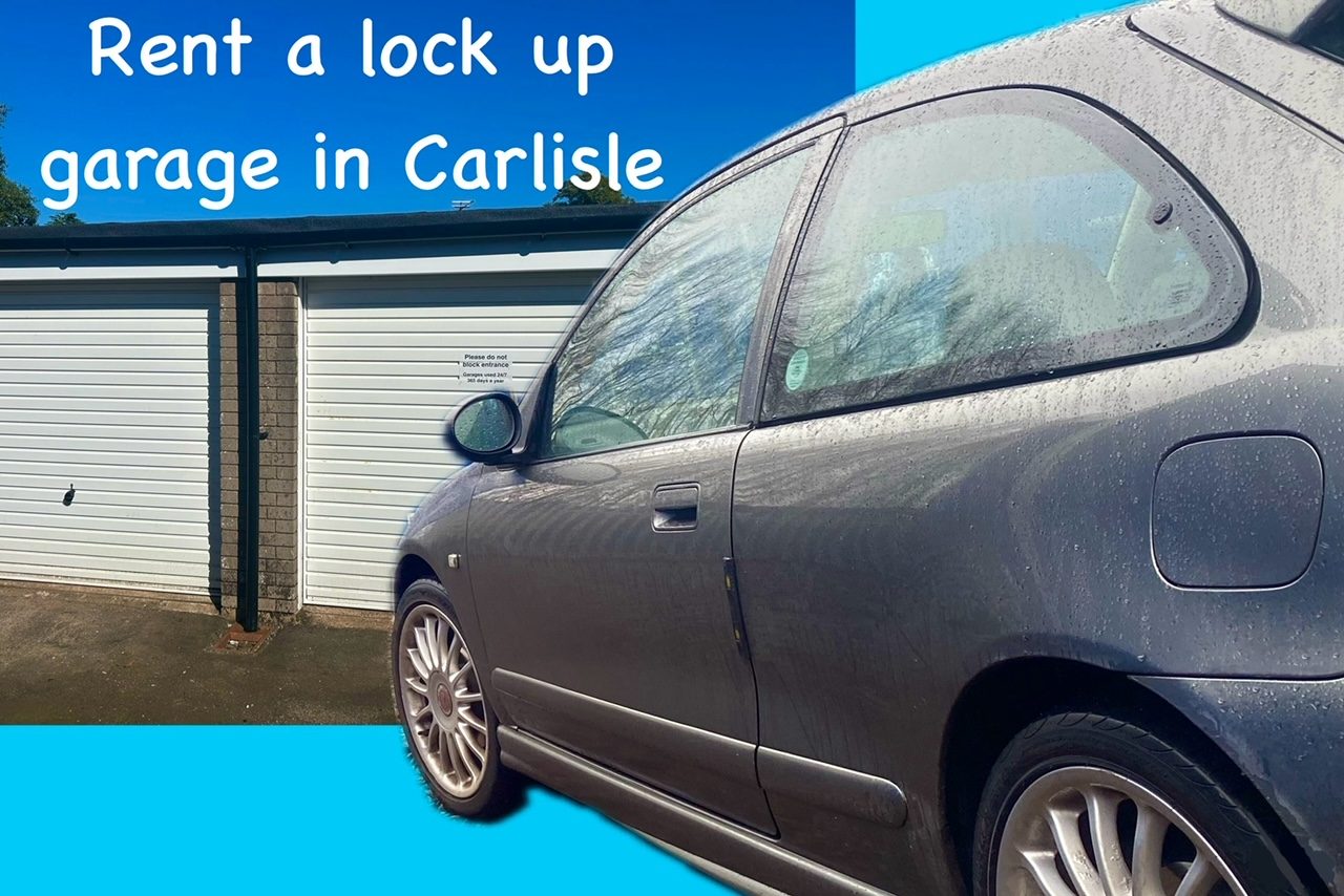 A classic sports car parked in front of two lock up garage storage units