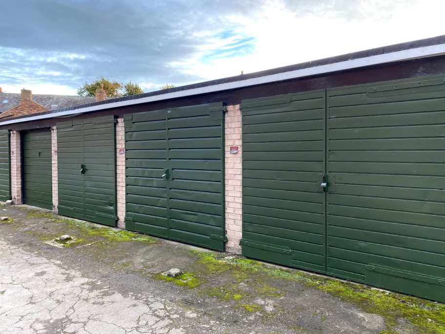 a row of lock up garages with metal doors