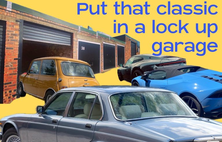 Classic motor cars beside lock up garages